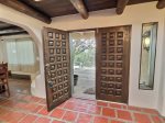 Formal entryway with double carved wood doors